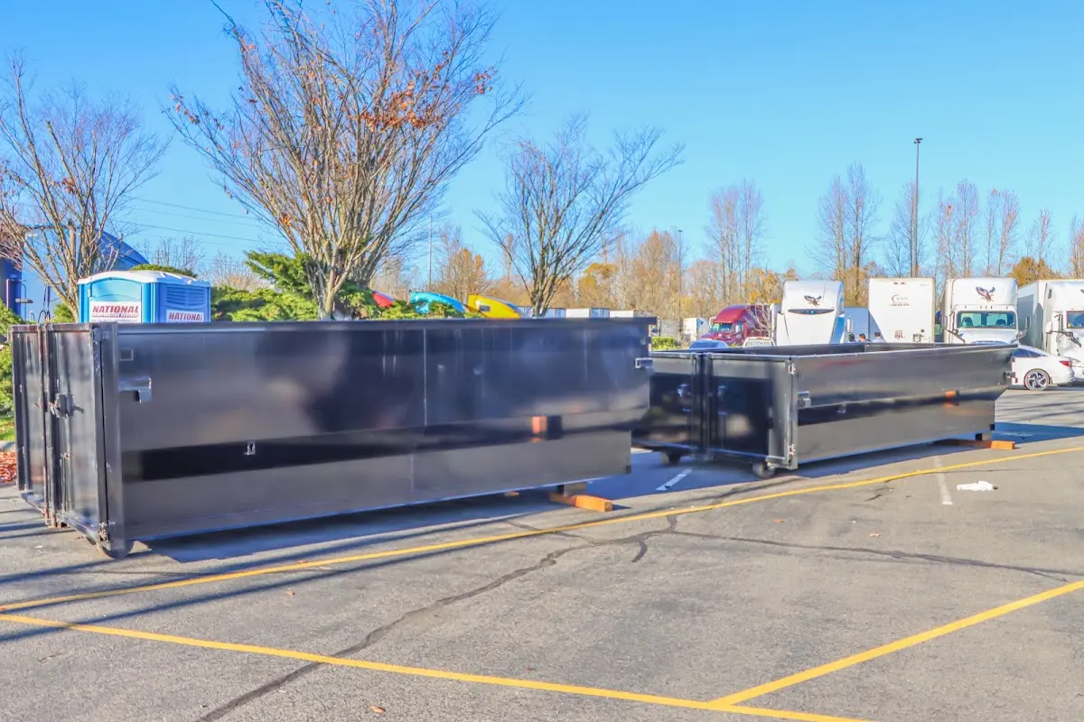 Professional dumpster rental service with roll-off container on residential driveway in Marrero